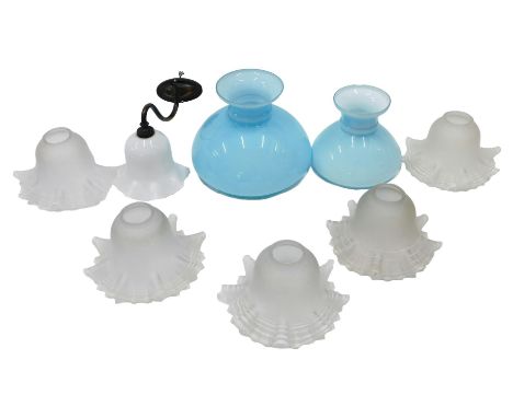 A collection of lamp shades, to include a set of five frosted examples, with petalated borders, two pale blue opaque shades, 