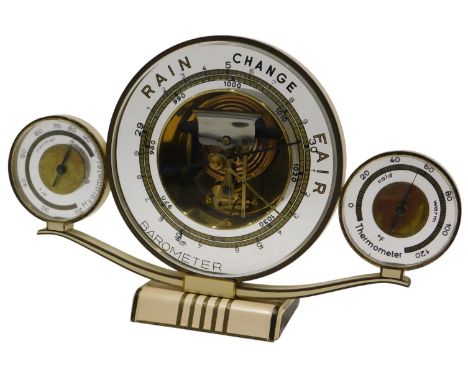 A German Art Deco Luffe weather station, to include barometer, hygrometer and thermometer, in cream and gilt case, 25cm wide.
