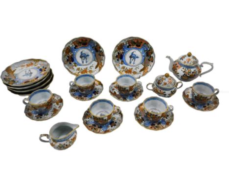 A Japanese porcelain part tea service, decorated in the Imari colours with flowers, leaves, birds, animals, etc.