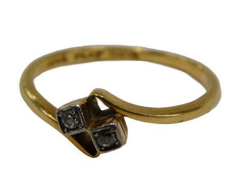 A diamond twist ring, set with two tiny diamonds in square setting, platinum, on a yellow metal band, stamped 18ct plat, ring