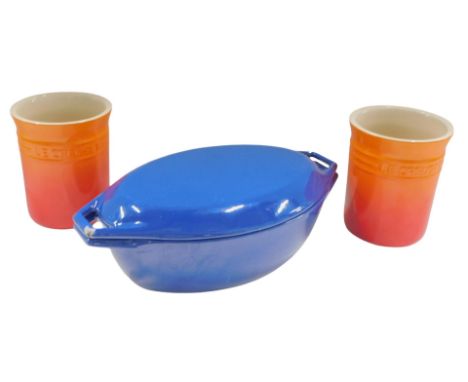 A Corpco Danish blue enamel Aga type casserole dish and cover, and a pair of Le Creuset 6" implement pots or crocks. (3)