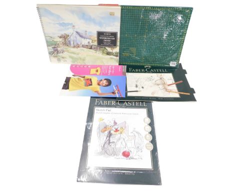 Various artists materials, cutting board, sketch pad, etc.