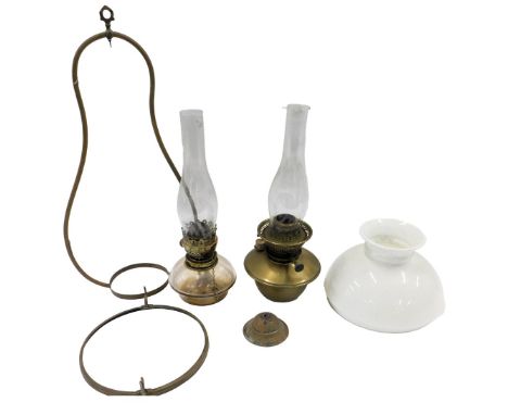 A late Victorian brass hanging oil lamp, with white opaque shade, and another part example with glass reservoir. (2)