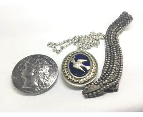 A Large Silver oval pendent set with blue enamel and a dove with attached belcher link chain a French 1889 Exhibition medalli