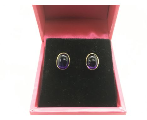 A pair of 9ct gold earrings set with cabochon amethyst