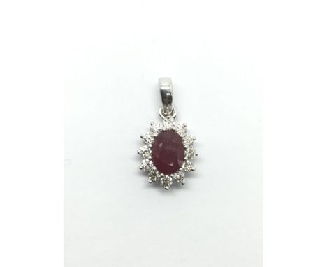 An 18ct white gold oval cut ruby and RBC diamond cluster pendant, ruby approx 1.25ct, diamonds approx 0.40ct, approx total we