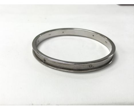 A boxed silver bangle set with diamonds. The approximate weight is 26g  - NO RESERVE