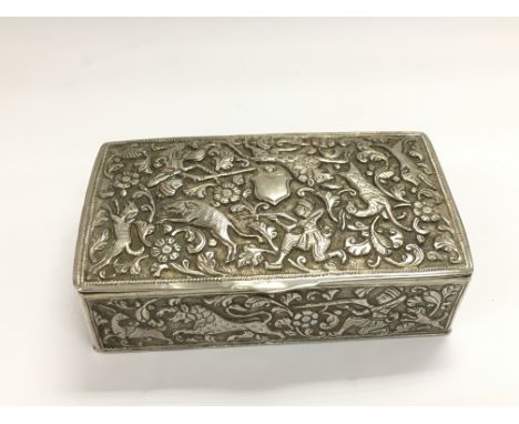 An Indian white metal box with elaborate hunting decoration, approx width 9cm.