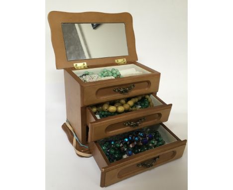 A small jewellery chest of drawers containing vintage jewellery various