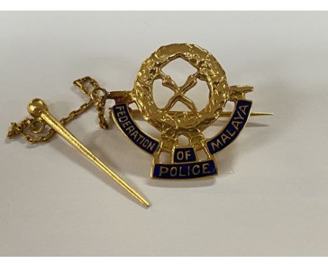 A high grade gold enamel badge for the Federation of Malaya Police together with a white metal example.