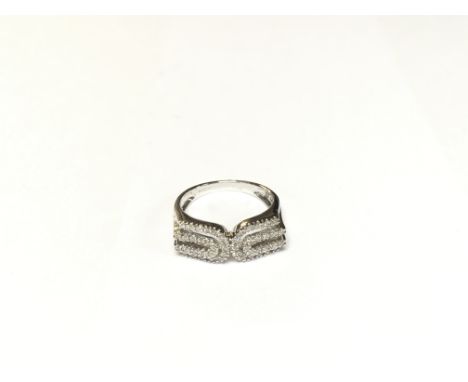 A modern style 14ct white gold diamond set ring. Size N.