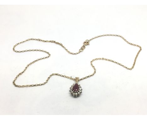 A 9ct gold ruby and diamond pendant on a gold chain, approx 3.2g.
