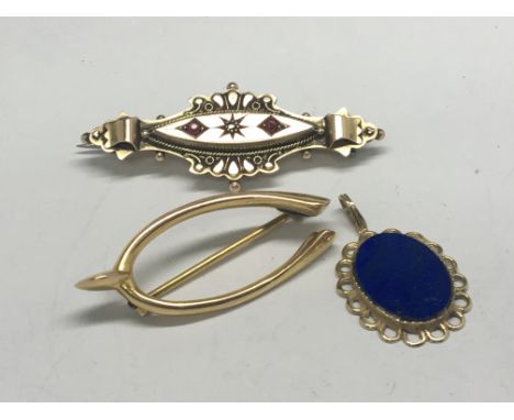 A 9ct gold brooch set with ruby and small diamond a gold wishbone brooch and a lapis Lazuli pendent (3)