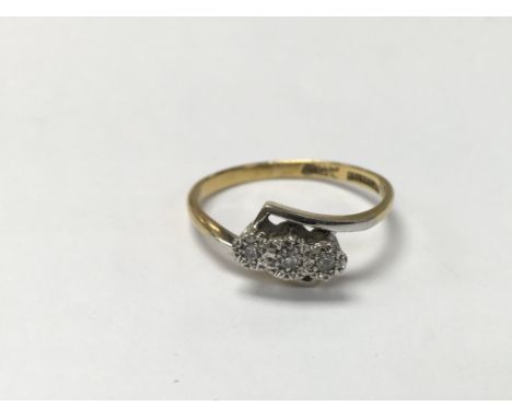 An 18ct gold cross over ring set with three diamonds. The approximate ring size is N.