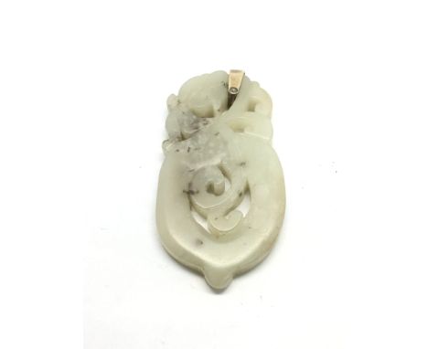 A carved jade pendant, approx length 6.5cm.