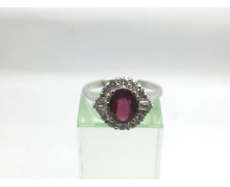 A certificated 18ct white gold, ruby and diamond cluster ring set with an oval cut ruby approx 1.45ct, RBC and tapered baguet