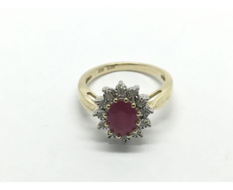 A 9ct gold, oval ruby and diamond cluster ring, ruby approx 1.61ct, diamonds approx 0.06ct and approx total weight 3.4g and a