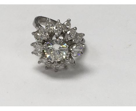 An 18 ct white gold ring with central diamond 1.7 ct surrounded by 16 marquise diamonds size N . With independent jewellery r