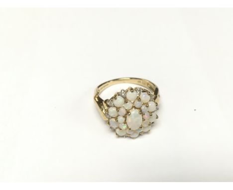An all opal set cluster ring in yellow gold. Size L.
