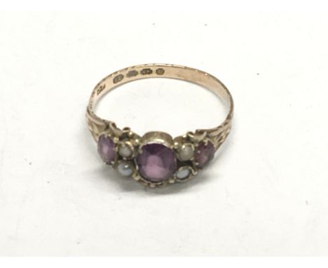 An unusual 12carat Antique gold ring set with amethyst and seed pearl. Ring size P weight 1.5g