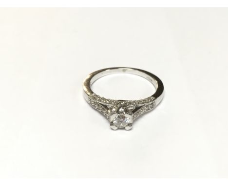 A very modern style diamond ring with diamond shoulders and sides. Size N.
