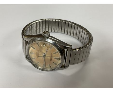 A gents vintage Rolex Oyster perpetual date, seen working, Later expanding strap.