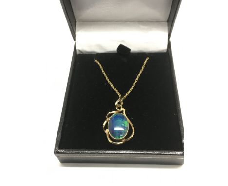A 9ct gold opal pendant suspended on a 9ct gold chain