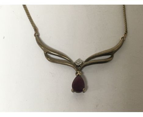A 9carat gold necklace set with a ruby and small diamond.weight 3.4g