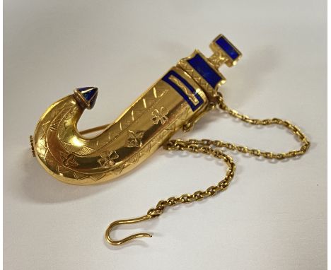An unmarked high grade gold Yemen Jambaya knife brooch inset with blue enamel.