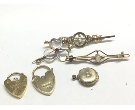 Three gold brooches set with seed pearl and Opal and other stones two gold padlock clasps and a miniature locket total weight