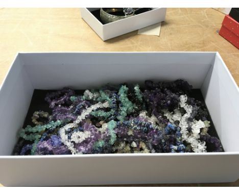 A box containing a quantity of rock crystal amethyst and other stone necklaces. (a lot)