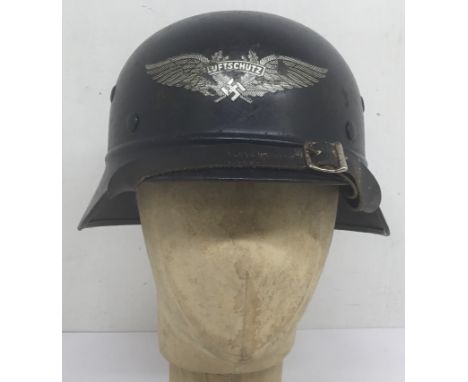 A WW2 era, German M35 Luftschutz helmet with beaded rim. Painted with blue / black finish, with standard Luftschutz decal to 
