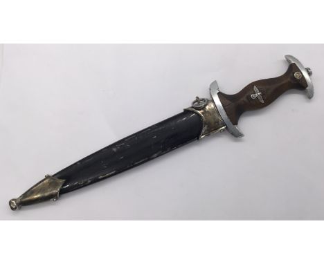 An early German SA / NSKK dagger, by August Bickel. A time worn example, with wooden handle and an inset eagle and SA motif. 