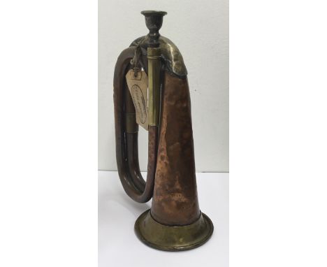A WW1 era 1916 dated military issued bugle. Manufactured in copper and brass, with the manufacturers mark of Thomas Dawkins &