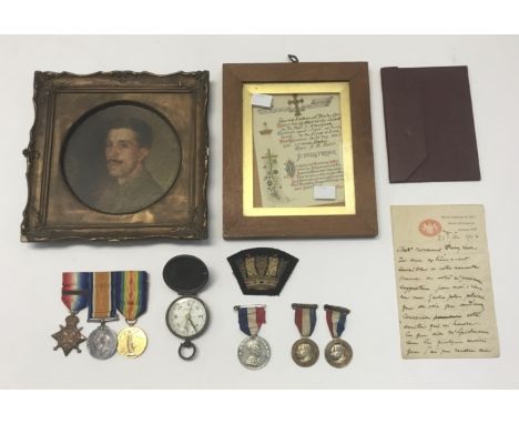 A WW1 officer’s 1914 Star with ‘Mons’ clasp, Prisoner of War medal trio, a portrait of the officer while in captivity, and ot