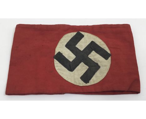 A WW2 German NSDAP party armband. Multi part construction, with folded grosgrain tape swastika, stitched upon a white roundel