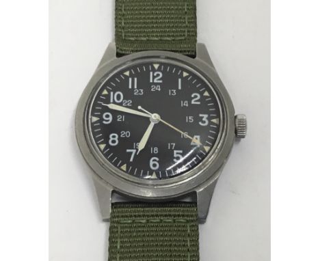 A vintage Vietnam War era GG-W-113 United States military wristwatch by Benrus. Dated May 1971 to the back cover, and the U.S