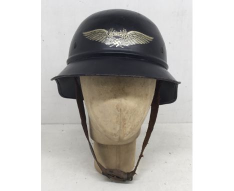 A WW2 era, German M38 Luftschutz ‘gladiator’ helmet. With a dark blue / black paint finish on a multi part construction shell