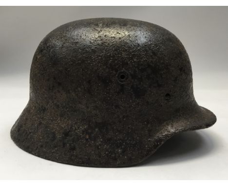 A WW2 era M35 German helmet shell in relic condition. Usual rolled over edge and separately applied ventilation holes. The he
