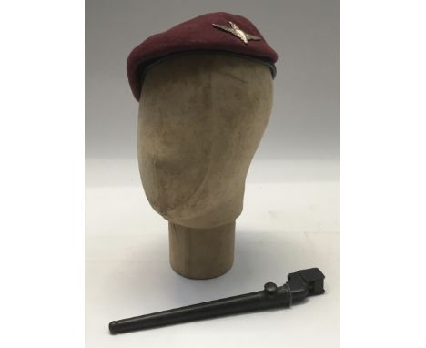 A post WW2 Parachute Regiment beret, fitted with an officer’s heavily silvered badge. Maroon wool body with leather sweatband