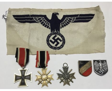 A selection of WW2 German insignia and medals. To include: an Iron Cross second class, marked ‘49’ to the suspension ring for