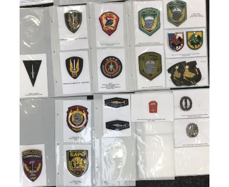 A good selection of British and European Special Forces embroidered patches, printed patches and metal badges. To include: Au