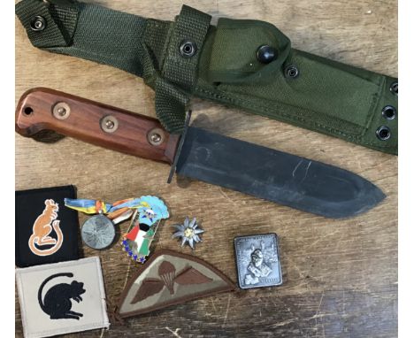 A 1980's British Army survival knife, complete with canvas sheath and frog. Marked with a broad arrow and dated 1984, with a 