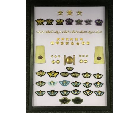 A good selection of Omani, Sultan of Oman Special Forces insignia, mounted on card backing and framed. To include: a gilt bra