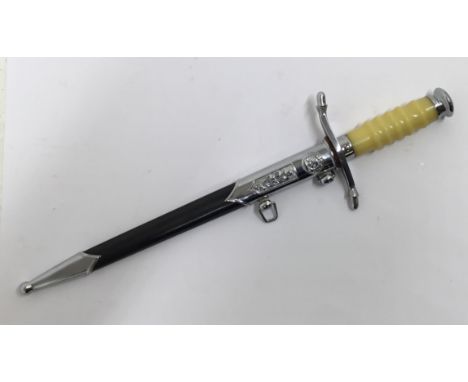 A vintage Post WW2, East German NVA army officers dagger, complete with scabbard. Ivory coloured and contoured plastic grips,