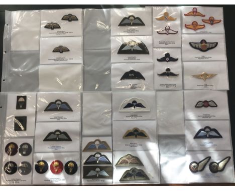 6 double sided album pages, containing numerous parachute qualification wings. Including embroidered, bullion, and metal exam