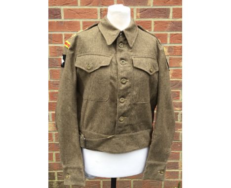 A late WW2 era 1940 pattern, 1945 dated British Army Battle Dress Blouse. Fitted with cloth shoulder titles for the Royal Arm