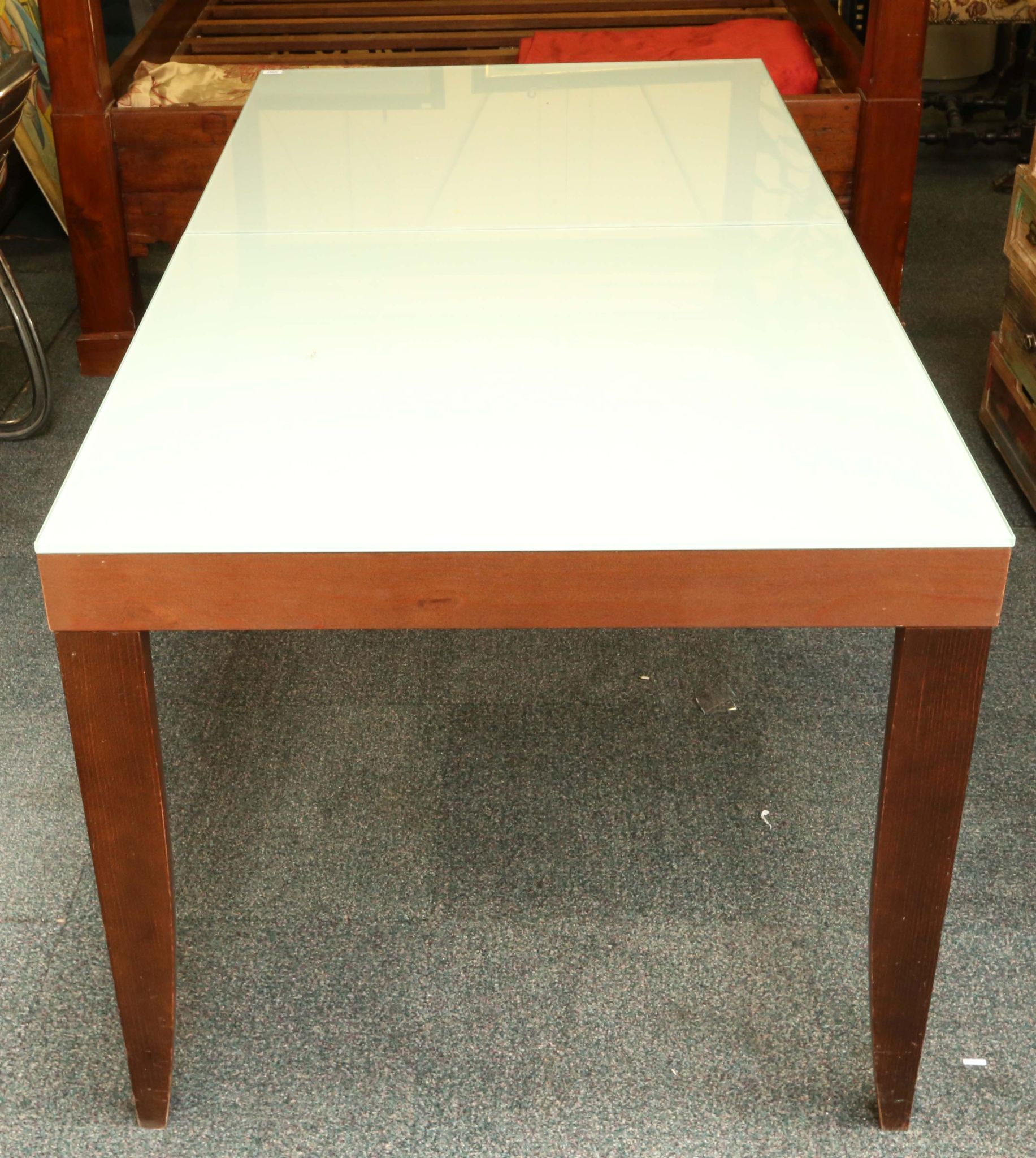 A modern Ligne Roset extending dining table, with frosted ...