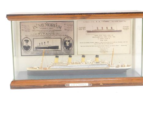 A scale model of the SS Titanic, in a wooden and perspex case, case 32cm W.