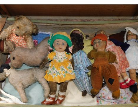 Six early 20thC cloth dolls, possibly Norah Wellings, together with a Teddy Bear, donkey and a dog, in a green canvas trunk, 